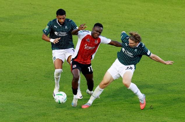Andrew Oluwabori of Exeter City with Xavier Amaechi and Alex Hartridge of Plymouth Argyle. Plymouth Argyle v Exeter City, EFL Carabao Cup, First Round, Football, Home Park, Plymouth, UK - 10 Aug 2026Plymouth Home Park United Kingdom EDITORIAL USE ONLY No use with unauthorised audio, video, data, fixture lists, club league logos or live services. Online in-match use limited to 120 images, no video emulation. No use in betting, games or single club league player publications.  Copyright: xJamesxMarsh Shutterstockx 17061088av