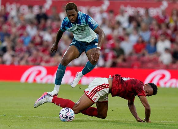 Nottingham, England, 12th August 2026. JeanuÃ«l Belocian of Bayer Leverkusen hurdles Dan Ndoye of Nottingham Forest during the Nottingham Forest vs Bayer Leverkusen Pre Season Friendly match at the City Ground, Nottingham. Picture credit should read: Andrew Yates Sportimage EDITORIAL USE ONLY. No use with unauthorised audio, video, data, fixture lists, club league logos or live services. Online in-match use limited to 120 images, no video emulation. No use in betting, games or single club league player publications. SPI_003_AY_NOTTS_FOREST_LEVERKUSEN SPI-4901-0002