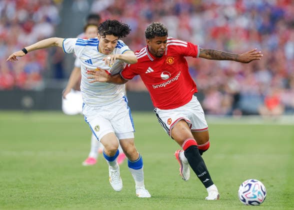 Dublin, Ireland, 12th August 2026. Ao Tanaka of Leeds United and Andrey Santos of Manchester United, ManU battle for the ball during the Manchester United vs Leeds United Pre Season Friendly match at Croke Park, Dublin. Picture credit should read: Cody Froggatt Sportimage EDITORIAL USE ONLY. No use with unauthorised audio, video, data, fixture lists, club league logos or live services. Online in-match use limited to 120 images, no video emulation. No use in betting, games or single club league player publications. SPI_040_CF_MANCHESTER_UNITED_V_LEEDS SPI-4900-0042