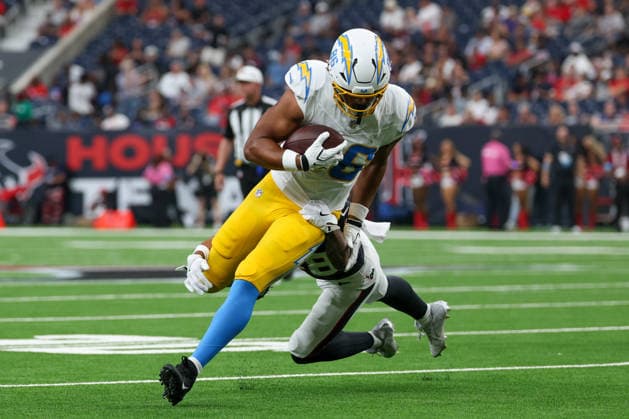 HOUSTON, TX - AUGUST 13: Tight End Oronde Gadsden of the Los Angeles Chargers runs with the ball as nickelback Alijah Huzzie of the Houston Texans wraps him up from behind during the NFL, American Football Herren, USA preseason game between Houston Texans and Los Angeles Chargers on August 13, 2026, at Reliant Stadium in Houston, TX. (Photo by David Buono Icon Sportswire) NFL: AUG 13 Chargers at Texans EDITORIAL USE ONLY Icon260813006