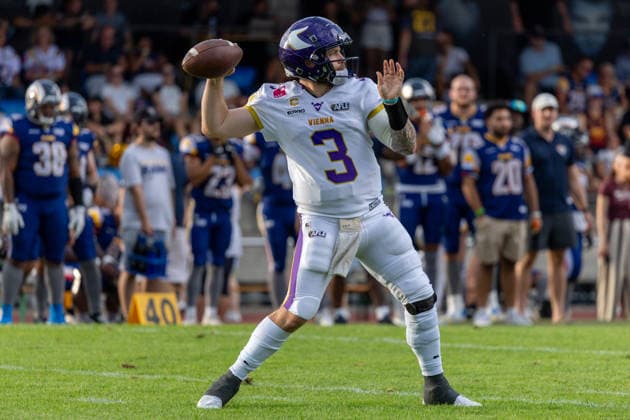 Ben Holmes (Vienna Vikings, 3) holds the football in his right hand while scanning the field with stadium seating visible in the background. Vienna Vikings at Alpine Rams, American Football, American Football League Europe, Week 13, 2026, 8.8.2026, Copyright: xPFA RicoxDoninellix