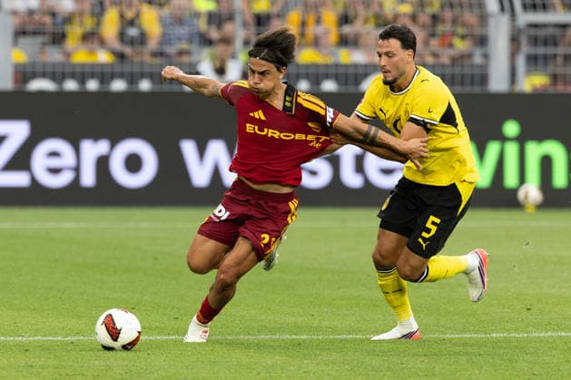 (260816) -- DORTMUND, Aug. 16, 2026 -- Ramy Bensebaini (R) of Borussia Dortmund vies with Paulo Dybala of Roma during a friendly football match between Borussia Dortmund of Germany and Roma of Italy in Dortmund, Germany, Aug. 15, 2026. (Photo by Xinhua) (SP)GERMANY-DORTMUND-FOOTBALL-FRIENDLY-DORTMUND VS ROMA JoachimxBywaletz 
