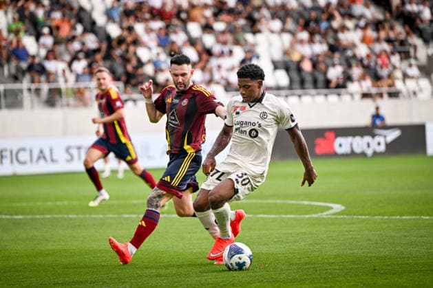 LUGANO, SWITZERLAND - AUGUST 16: Dereck Moncada of Lugano protects the ball from Dusan Cvetkovic of Vedeggio during the Swiss Cup match between Vedeggio Calcio and FC Lugano at AIL Arena on August 16, 2026 in Lugano, Switzerland. Lugano AIL Arena Ticino Switzerland *** LUGANO, SWITZERLAND, AUGUST 16 — Dereck Moncada of Lugano shields the ball from Dusan Cvetkovic of Vedeggio during the Swiss Cup match between Vedeggio Calcio and FC Lugano at the AIL Arena on August 16, 2026, in Lugano, Switzerland. Lugano, AIL Arena, Ticino, Switzerland Copyright: xJustPictures.ch AndreaxBrancax jp-en-EuSpIm-AB_16082026_4675
