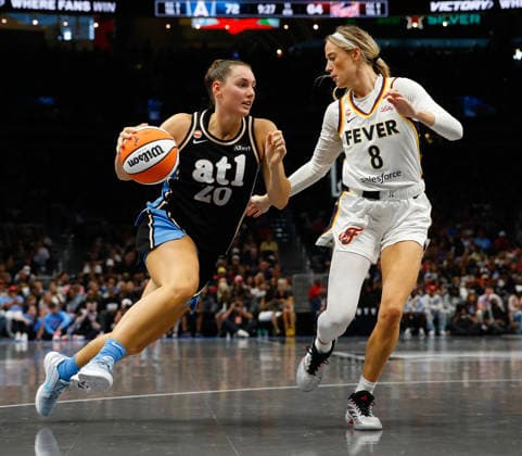 Guard Sophie Cunningham 8 of the Indiana Fever defends against guard Isobel Borlase 20 of the Atlanta Dream in the second half at State Farm Arena on Sunday, August 16, 2026 in Atlanta, Georgia.  ATL20260816124 MikexZarrilli