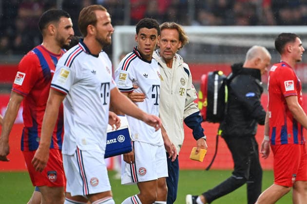 Jamal MUSIALA (Bayern Muenchen) bricht erneut zusammen,Ohnmacht, wird von Dr.Peter UEBLACKER (Mannschaftsarzt FCB) vom Platz gefuehrt, li:Harry KANE (Bayern Muenchen). Fussball Testpiel 1.FC Heidenheim - FC Bayern Muenchen am 18.08.2025 , VOITH ARENA. *** Jamal MUSIALA of Bayern Munich collapses again;faints, is led off the field by Dr. Peter UEBLACKER, FCB team doctor; featuring Harry KANE in a Bayern Munich soccer exhibition match: FC Heidenheim vs. FC Bayern Munich on August 18, 2025, at VOITH ARENA