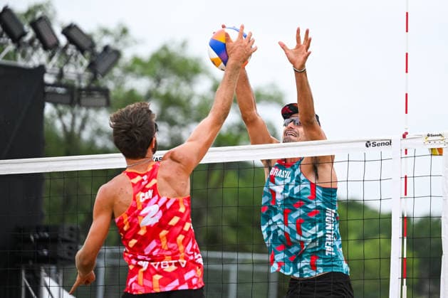 MONTREAL, QC - AUGUST 19: Andre Loyola Stein (BRA) blocks Henry Heider (CAN) smash during a qualification match at Beach Pro Tour Montreal Elite 16 on August 19, 2026 at Parc Jean-Drapeau in Montreal, QC (Photo by David Kirouac Icon Sportswire) VOLLEYBALL: AUG 19 Beach Pro Tour Montreal Elite 16 EDITORIAL USE ONLY Icon26081901226