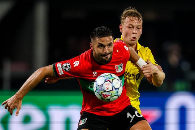 NIJMEGEN, NETHERLANDS - AUGUST 19: Dusan Tadic of NEC Nijmegen is challenged by Sondre Auklend of FK Bodo Glimt during the UEFA Champions League 2026 27 play-offs first leg match between N.E.C. Nijmegen and FK Bodo Glimt at Goffertstadion on August 19, 2026 in Nijmegen, Netherlands.  Copyright: xRenexNijhuis MBxMediax
