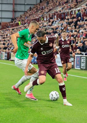 Heart of Midlothian v SK Rapid Wien UEFA Europa Conference League Tom Renaud of Heart of Midlothian is tackled by Nenad CvetkoviÄ‡ of SK Rapid Wien during the UEFA Europa Conference League Play-Off First Leg match at Tynecastle Park, Edinburgh 20 08 2026 UK Newspapers OUT Copyright: xFredxPalmerx FIL-23809-0131