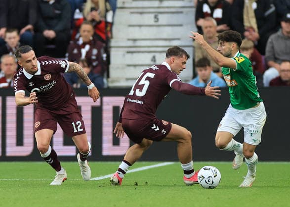 Heart of Midlothian v SK Rapid Wien UEFA Europa Conference League Tom Renaud of Heart of Midlothian (left) and Josh McPake of Heart of Midlothian (middle) defends against Yusuf Demir of SK Rapid Wien (right) during the UEFA Europa Conference League Play-Off First Leg match at Tynecastle Park, Edinburgh 20 08 2026 UK Newspapers OUT Copyright: xFredxPalmerx FIL-23809-0181