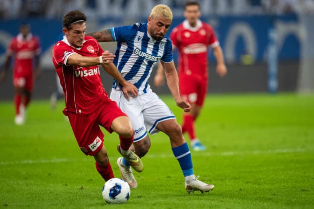 Allahyar Sayyadmanesh of KKS Lech Poznan tackles Fabio Saiz of FC Thun during UEFA Europa League - Playoff Round season 26 27 match between teams of KKS Lech Poznan and FC Thun (Ruslan Taran Ball Raw Images) Poznan Enea Stadium Poland Copyright: xRuslanxTaranx _IMG6453