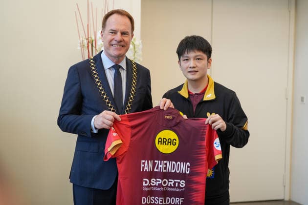 DUSSELDORF, GERMANY - AUGUST 20: Fan Zhendong (R) gives his jersey to Stephan Keller, mayor of Dusseldorf, during the welcoming ceremony on August 20, 2026 in Dusseldorf, Germany. Chinese Table tennis, Tischtennis star Fan Zhendong was officially unveiled by his new club Borussia Dusseldorf at a press conference, PK, Pressekonferenz on Thursday, as the Olympic champion prepares for his second season in the German Table Tennis Bundesliga and another campaign in European competition.  Copyright: xVCGx 111661096489
