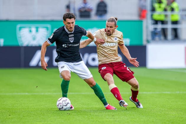 2026.08.21, xkwix, Fußball, DFB-Pokal, Preußen Münster - Karlsruher SC, LVM-Preußenstadion, 1.Runde, Saison 2026 2027: Charalambos Makridis (Preussen Muenster 14) im Zweikampf gegen Sebastian Jung (Karlsruher SC 2) DFB regulations prohibit any use of photographs as image sequences and or quasi-video. Photo: xKamilxWilkowskixPressefotoKochx Nordrhein-Westfalen Deutschland *** August 21, 2026, xkwix, Soccer, DFB Cup, Preußen Münster vs. Karlsruher SC, LVM Preußenstadion, Round 1, 2026–2027 Season: Charalambos Makridis of Preußen Münster (No. 14) in a tackle against Sebastian Jung of Karlsruher SC (No. 2). DFB regulations prohibit any use of photographs as image sequences and or quasi-video. Photo: xKamilxWilkowskixPressefotoKochx, North Rhine-Westphalia, Germany