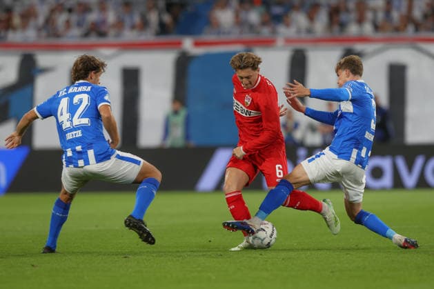 21.08.2026, xtgx, Fussball DFB-Pokal 1. Runde, FC Hansa Rostock - VfB Stuttgart, v.l. Benno Dietze (Rostock, 42), Angelo Stiller (Stuttgart, 6), Florian Bohnert (Rostock, 3) Zweikampf, Duell, Kampf, tackle (DFL DFB REGULATIONS PROHIBIT ANY USE OF PHOTOGRAPHS as IMAGE SEQUENCES and or QUASI-VIDEO) Rostock *** August 21, 2026, xtgx, Soccer DFB Cup First Round, FC Hansa Rostock vs. VfB Stuttgart, from left: Benno Dietze (Rostock), 42, Angelo Stiller, Stuttgart, 6, Florian Bohnert, Rostock, 3, tackle, duel, battle, DFL and DFB regulations prohibit any use of photographs as image sequences and or quasi-video, Rostock