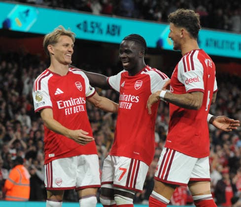 Football - 2026 - 227 - Arsenal v Coventry City FA Premiership at Emirates Stadium - Friday 21st August 2026 Martin Odegaard of Arsenal celebrates scoring goal no.3 with Bukayo Saka and Ben White 