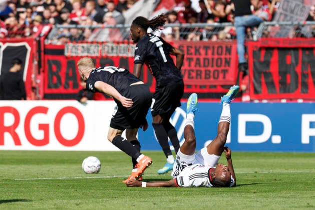 KOELN, GERMANY - AUGUST 22, 2026: Mohamed Alì Zoma (1. FC Nuernberg, 23) tackled by Meiko Sponsel (Viktoria Koeln, 19) and Yannick Tonye (Viktoria Koeln, 7) during the DFB-Cup match between Viktoria Koeln vs. 1. FC Nuernberg at the Sportpark Hoehenberg on August 22, 2026 in Koeln, Germany. DFL REGULATIONS PROHIBIT ANY USE OF PHOTOGRAPHS AS IMAGE SEQUENCES AND OR QUASI-VIDEO. Nordrhein-Westfalen Germany Copyright: xAxelxKohringx