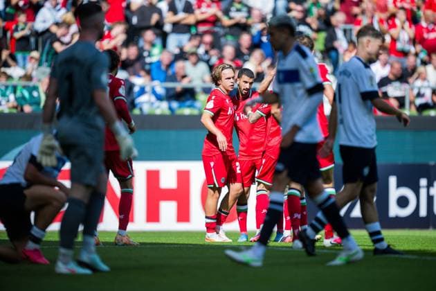 22.08.2026 - Fußball, 2026 2027, DFB-Pokal, 1. Hauptrunde, SV Hemelingen - Hannover 96: (L-R) Lars Gindorf (Hannover) jubelt nach seinem Tor zum 0:2 mit Waniss Taibi (Hannover) DFB REGULATIONS PROHIBIT ANY USE OF PHOTOGRAPHS AS IMAGE SEQUENCES AND OR QUASI-VIDEO. *** August 22, 2026 Soccer, 2026–2027, DFB Cup, 1st Round, SV Hemelingen vs. Hannover 96. Lars Gindorf of Hannover celebrates his goal to make it 0–2 with Waniss Taibi. Hannover. DFB regulations prohibit any use of photographs as image sequences and or quasi-video.