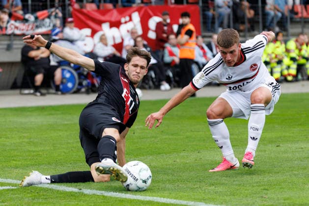 KOELN, GERMANY - AUGUST 22, 2026: Pascal Fallmann (Viktoria Koeln, 28) and Tobias Heß (1. FC Nuernberg, 43) during the DFB-Cup match between Viktoria Koeln vs. 1. FC Nuernberg at the Sportpark Hoehenberg on August 22, 2026 in Koeln, Germany. DFL REGULATIONS PROHIBIT ANY USE OF PHOTOGRAPHS AS IMAGE SEQUENCES AND OR QUASI-VIDEO. Nordrhein-Westfalen Germany Copyright: xAxelxKohringx