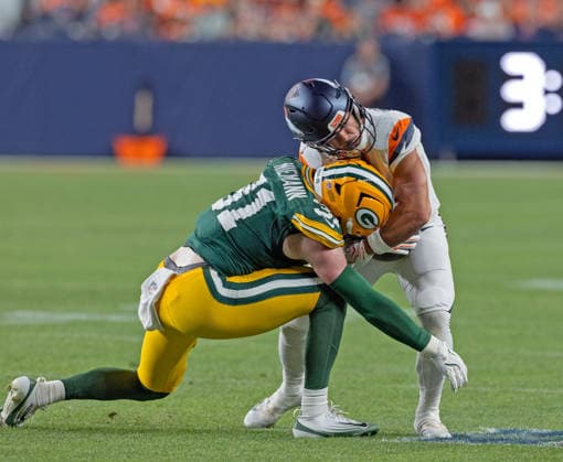 August 22, 2026, Denver, Colorado, USA: Broncos RB CODY SCHRADER gets hit hard by Packers LB NICK NIEMANN during the 2nd. Half at Empower Field at Mile High Friday evening. Packers beat the Broncos in Pre-Season 33-13. Credit Image: ZUMA Press Wire) Denver USA - ZUMAav4_ 20260822_zaf_av4_023 Copyright: xHectorxAcevedox