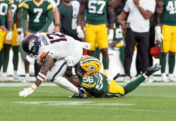 August 22, 2026, Denver, Colorado, USA: Broncos RB RJ HARVEY runs upfield with Packers LB EDGERRIN COOPER making a tackle from behind during the 1st. Half at Empower Field at Mile High Friday evening. Packers beat the Broncos in Pre-Season 33-13. Credit Image: ZUMA Press Wire) Denver USA - ZUMAav4_ 20260822_zaf_av4_036 Copyright: xHectorxAcevedox