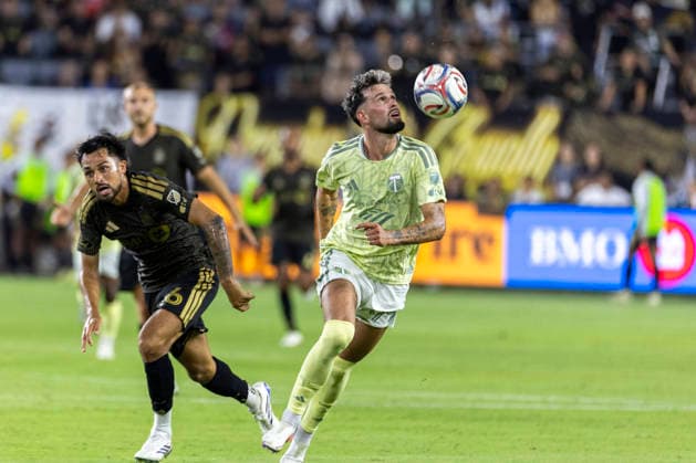 August 22, 2026, Los Angeles, California, USA: Portland Timbers forward Kristoffer Velde (99) heads the ball away from Los Angeles FC midfielder Mathieu Choiniere (66) during a MLS, Fussball Herren, USA soccer game at BMO Stadium on Saturday, Aug. 22, 2026 in Los Angeles. Los Angeles USA - ZUMAc68_ 20260822_zaf_c68_174 Copyright: xRingoxChiux
