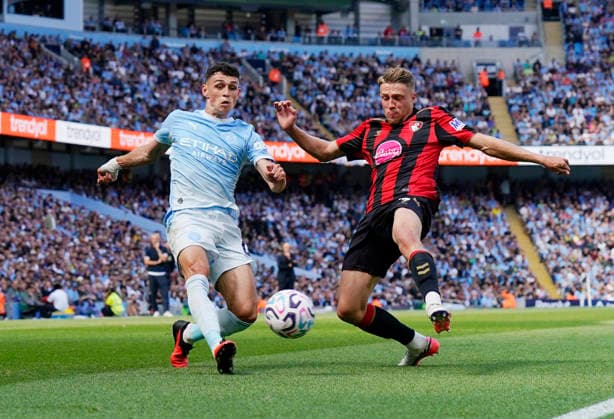 Manchester, England, 23rd August 2026. Phil Foden of Manchester City and Adrien Truffert of Bournemouth during the Manchester City vs AFC Bournemouth Premier League match at the Etihad Stadium, Manchester. Picture credit should read: Andrew Yates Sportimage EDITORIAL USE ONLY. No use with unauthorised audio, video, data, fixture lists, club league logos or live services. Online in-match use limited to 120 images, no video emulation. No use in betting, games or single club league player publications. SPI_029_AY_Man_City_Bournemouth SPI-4930-0028