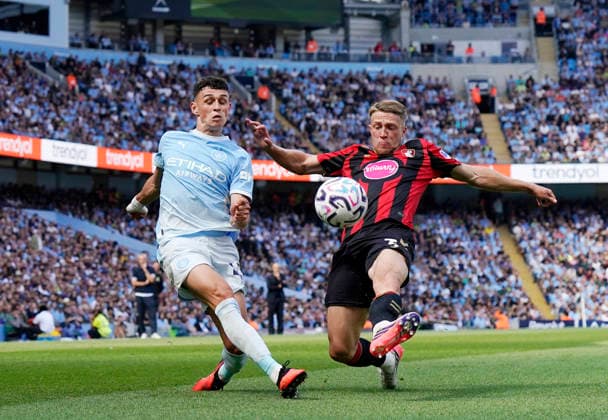 Manchester, England, 23rd August 2026. Phil Foden of Manchester City and Adrien Truffert of Bournemouth during the Manchester City vs AFC Bournemouth Premier League match at the Etihad Stadium, Manchester. Picture credit should read: Andrew Yates Sportimage EDITORIAL USE ONLY. No use with unauthorised audio, video, data, fixture lists, club league logos or live services. Online in-match use limited to 120 images, no video emulation. No use in betting, games or single club league player publications. SPI_034_AY_Man_City_Bournemouth SPI-4930-0033