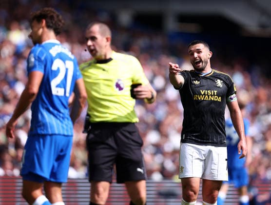Brighton and Hove, England, 23rd August 2026. John McGinn of Aston Villa (r) laughs at Olivier Boscagli of Brighton as he gets booked during the Brighton and Hove Albion vs Aston Villa Premier League match at the AMEX Stadium, Brighton and Hove. Picture credit should read: Paul Terry Sportimage EDITORIAL USE ONLY. No use with unauthorised audio, video, data, fixture lists, club league logos or live services. Online in-match use limited to 120 images, no video emulation. No use in betting, games or single club league player publications. SPI_018_PT_Brighton_Villa SPI-4931-0022