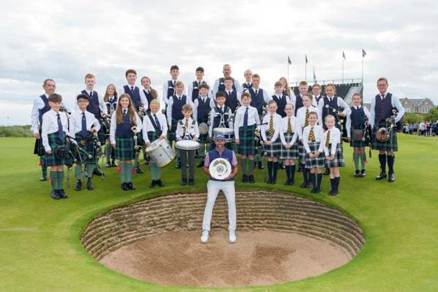 BALMEDIE, SCOTLAND - AUG 23: Scott Jamieson (SCO) holds the Nexo Trophy with the Robert Gordon Academy Pipe band after Round 4 at the 2026 Nexo Championship at the Trump International Golf Links, Balmedie on August 23, 2026 in Aberdeenshire, Scotland The 2026 Nexo Championship