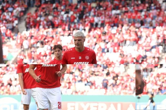 Marek Janssen von Rot-Weiss Essen steht konzentriert vor der vollbesetzten, rot gekleideten Fankurve im Stadion an der Hafenstraße. Der Spieler ist im Halbporträt zu sehen, der Hintergrund mit den Fans ist weichgezeichnet. Marek Janssen (Rot-Weiss Essen) konzentriert vor der Fankurve *** Marek Janssen of Rot Weiss Essen stands focused in front of the packed fan section, dressed in red, at the stadium on Hafenstraße. The player is shown in a half-length portrait, with the background featuring the fans blurred. Marek Janssen of Rot Weiss Essen stands focused in front of the fan section. Copyright: xspeedshotx xTimoxBluhmki-Schmidtx