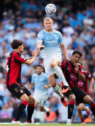 Erling Haaland of Manchester City jumps for the ball with Bournemouth defenders James Hill (left) and Antonio Silva (14) Manchester City v Bournemouth, Premier League, Football, Etihad Stadium, Manchester, UK - 23 Aug 2026Manchester Etihad Stadium United Kingdom EDITORIAL USE ONLY No use with unauthorised audio, video, data, fixture lists, club league logos or live services. Online in-match use limited to 120 images, no video emulation. No use in betting, games or single club league player publications.  Copyright: xWiredxPhotos Shutterstockx 17113667ec