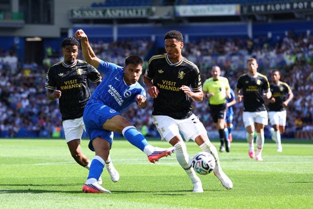 Brighton and Hove, England, 23rd August 2026. Diego Gomez of Brighton & Hove Albion has a shot on goal under pressure from George Hemmings of Aston Villa during the Brighton and Hove Albion vs Aston Villa Premier League match at the AMEX Stadium, Brighton and Hove. Picture credit should read: Paul Terry Sportimage EDITORIAL USE ONLY. No use with unauthorised audio, video, data, fixture lists, club league logos or live services. Online in-match use limited to 120 images, no video emulation. No use in betting, games or single club league player publications. SPI_125_PT_Brighton_Villa SPI-4931-0128