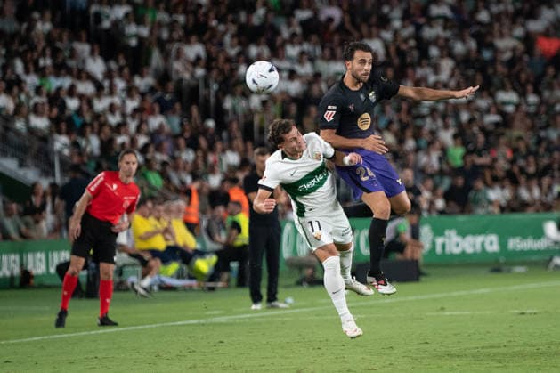 August 23, 2026, Elche, Alicante, Spain: 24 ERIC GARCIA heading against 11 GERMAN VALERA during the match between Elche CF and FC Barcelona, Barca from LaLiga EASports, matchweek 2, disputed at the MartoÂ­nez Valero stadium, Alicante Elche Spain - ZUMAc290 20260823_zsp_c290_052 Copyright: xJordixCantox