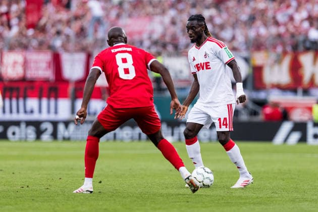 WUERZBURG, GERMANY - AUGUST 24: Gideon Mensah (1. FC Koeln, 14) controls the ball against David Kinsombi (Wuerzburger Kickers, 8) during the 1st round DFB Pokal match between Wuerzburger Kickers vs. 1. FC Koeln at AKON ARENA on August 24, 2026 in Wuerzburg, Germany. DFB REGULATIONS PROHIBIT ANY USE OF PHOTOGRAPHS AS IMAGE SEQUENCES AND OR QUASI-VIDEO. Bavaria Germany Copyright: xSteffiexWunderlx