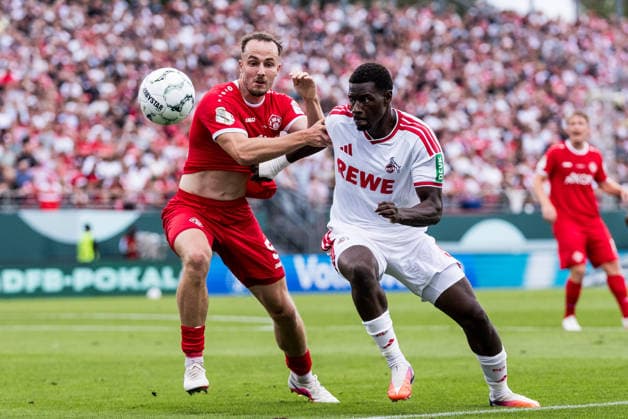 WUERZBURG, GERMANY - AUGUST 24: Ragnar Ache (1. FC Koeln, 9) and Leo Eberle (Wuerzburger Kickers, 5) battle for the ball during the 1st round DFB Pokal match between Wuerzburger Kickers vs. 1. FC Koeln at AKON ARENA on August 24, 2026 in Wuerzburg, Germany. DFB REGULATIONS PROHIBIT ANY USE OF PHOTOGRAPHS AS IMAGE SEQUENCES AND OR QUASI-VIDEO. Bavaria Germany Copyright: xSteffiexWunderlx