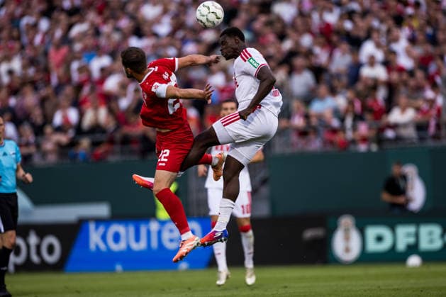 WUERZBURG, GERMANY - AUGUST 24: Daniel Haegele (Hägele, Wuerzburger Kickers, 22) and Ragnar Ache (1. FC Koeln, 9) battle for the ball during the 1st round DFB Pokal match between Wuerzburger Kickers vs. 1. FC Koeln at AKON ARENA on August 24, 2026 in Wuerzburg, Germany. DFB REGULATIONS PROHIBIT ANY USE OF PHOTOGRAPHS AS IMAGE SEQUENCES AND OR QUASI-VIDEO. Bavaria Germany Copyright: xSteffiexWunderlx