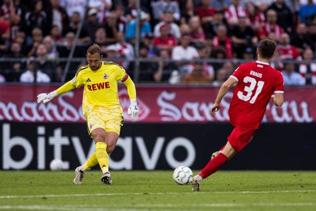 WUERZBURG, GERMANY - AUGUST 24: Marvin Schwaebe (Schwäbe, Schwabe, 1. FC Koeln, 1) controls the ball against Tim Kraus (Wuerzburger Kickers, 31) during the 1st round DFB Pokal match between Wuerzburger Kickers vs. 1. FC Koeln at AKON ARENA on August 24, 2026 in Wuerzburg, Germany. DFB REGULATIONS PROHIBIT ANY USE OF PHOTOGRAPHS AS IMAGE SEQUENCES AND OR QUASI-VIDEO. Bavaria Germany Copyright: xSteffiexWunderlx