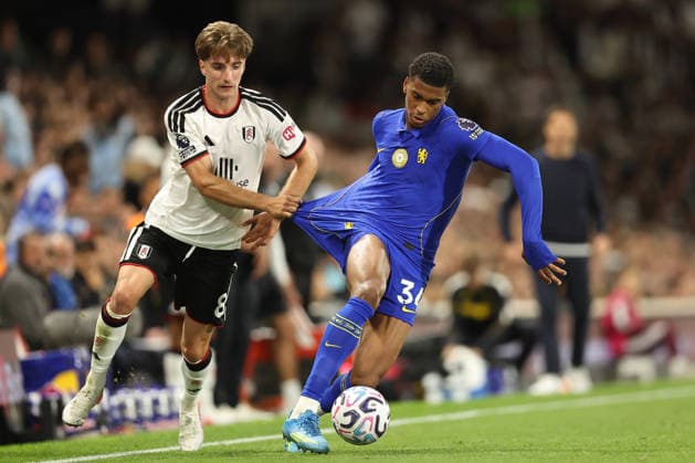 24th August 2026; Craven Cottage, Fulham, London, England; Premier League Football, Fulham versus Chelsea; Josh Acheampong of Chelsea keeps the ball from Cesar Palacios of Fulham KatiexChan
