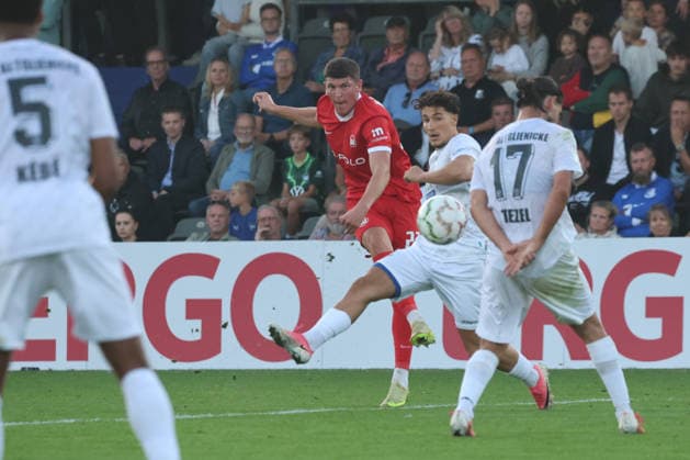 BERLIN, GERMANY - AUGUST 24: Alessio Besio (Wolfsburg, 23) shoots at the goal against Ogulcan Tezel (VSG Altglienicke, 17), during the DFB Cup DFB Pokal match (Round 1) between DFB-Pokal: VSG Altglienicke - VfL Wolfsburg at Stadion auf dem Wurfplatz (Amateurstadion im Olympiapark) on August 24, 2026 in Berlin, Germany. DFL REGULATIONS PROHIBIT ANY USE OF PHOTOGRAPHS AS IMAGE SEQUENCES AND OR QUASI-VIDEO. Berlin Germany Copyright: xO.Frankex