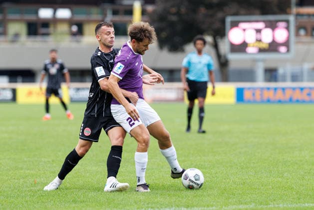 Elias Herzig, 24, of TSV Schwaben Augsburg, and Timo Spennesberger, 8, of TSV Landsberg, during the match between TSV Landsberg and TSV Schwaben Augsburg, soccer, men’s, Toto Cup, 2026–2027, Round of 16 on August 25, 2026, in Landsberg am Lech, Sportpark Bayern, Germany
