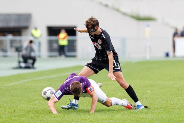 Kilian Pittrich, 21, TSV Landsberg, and Dennis Ruisinger, 5, TSV Schwaben Augsburg, during the match between TSV Landsberg and TSV Schwaben Augsburg, soccer, men s, Toto Cup, 2026–2027, Round of 16 on August 25, 2026, in Landsberg am Lech, Sportpark Bayern, Germany