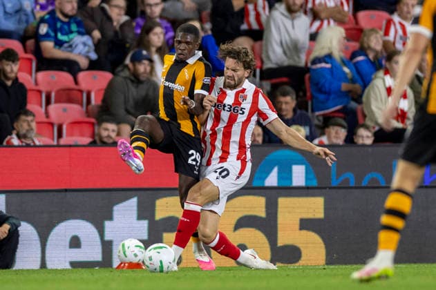 25th August 2026; Bet365 Stadium, Stoke, Staffordshire, England; Carabao Cup Football, Stoke City versus Hull City; Sam Gallagher of Stoke City is tackled by Lucas Gourna-Douath of Hull City TimxWilliams