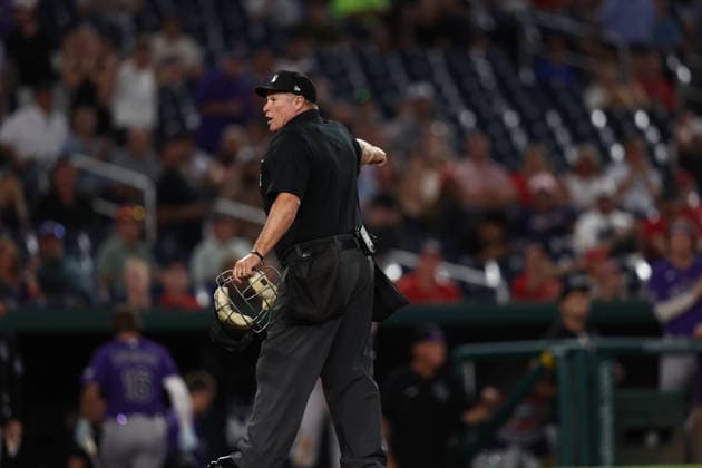 August 25, 2026, Washington D.C, District Of Columbia, United States: Washington, DC; Home plate umpire Marvin Hudson (51) explains the interference call during the Major League Baseball game between the Washington Nationals and the Colorado Rockies at Nationals Park on Tuesday, August 25, 2026. The Rockies beat the Nationals 3-1. MLB, Baseball Herren, USA Colorado Rockies 3:1 Washington Nationals  - ZUMAp258 20260825_znp_p258_017 Copyright: xStevexPrakopex