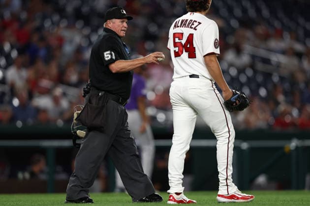August 25, 2026, Washington D.C, District Of Columbia, United States: Washington, DC; Home plate umpire Marvin Hudson (51) hands a new ball to Washington Nationals pitcher Andrew Alvarez (54) during the Major League Baseball game between the Washington Nationals and the Colorado Rockies at Nationals Park on Tuesday, August 25, 2026. The Rockies beat the Nationals 3-1. MLB, Baseball Herren, USA Colorado Rockies 3:1 Washington Nationals  - ZUMAp258 20260825_znp_p258_055 Copyright: xStevexPrakopex