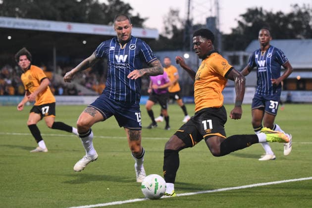 Cambridge United v Millwall - Carabao Cup Second Round Sullay Kaikai of Cambridge United crosses the ball under pressure from Lyndon Dykes of Millwall during the Carabao Cup Second Round match between Cambridge United and Millwall at the Cledara Abbey Stadium in Cambridge, on August 25, 2026. Cambridge Cambridgeshire  Copyright: xMIxNewsx originalFilename:fletcher-cambridg260825_npYML.jpg
