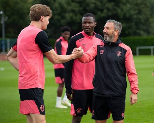Rangers manager Derek McInnes shakes hands with Ryan Naderi at training ahead of tomorrow s UEFA Conference League qualifying match against Jablonec. Rangers Training - The Rangers Training Centre, Glasgow, Lanarkshire, Scotland, UK - 26 Aug 2026Glasgow The Rangers Training Centre Lanarkshire United Kingdom  Copyright: xO Rourke RangersxFC Shutterstockx 17117524x