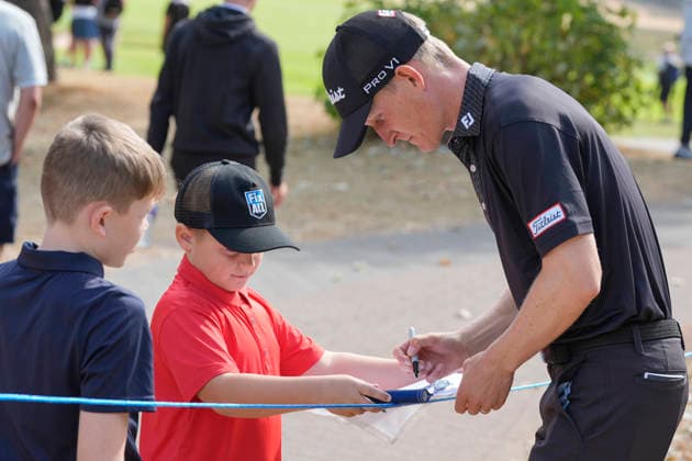 SUTTON COLDFIELD, ENGLAND - AUG 26: Marcus Kinhult (SWE) signs an autograph for a young fan during the Pro-Am at the 2026 Husqvarna British Masters at The Belfry, Sutton Coalfield on August 26, 2026 in Warwickshire, England The 2026 Husqvarna British Masters
