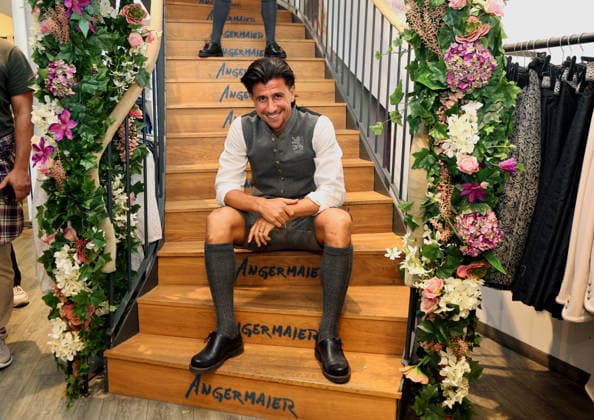 Soccer, Men s, Oktoberfest Attire, 2026–2027 Season, TSV 1860 Munich, Angermaier Traditional Attire: Tunay Deniz of TSV 1860 Munich sitting on the stairs in traditional attire, wearing lederhosen