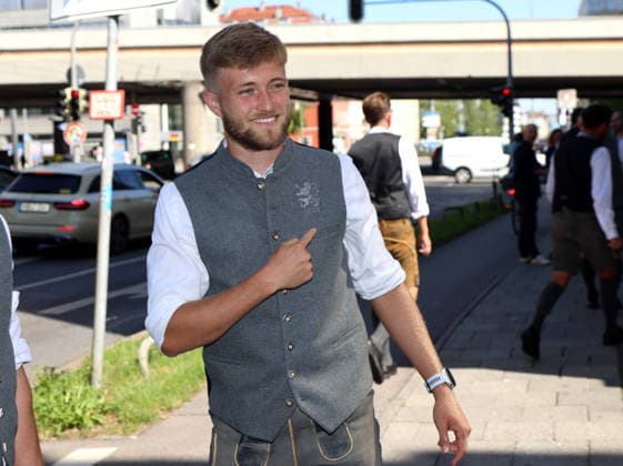 Soccer, Men s, Oktoberfest Uniforms, 2026–2027 Season, TSV 1860 Munich, Traditional Attire by Angermaier: Matthew Collins of TSV 1860 Munich points to the 1860 logo and the lion on his traditional jacket while wearing traditional attire and lederhosen