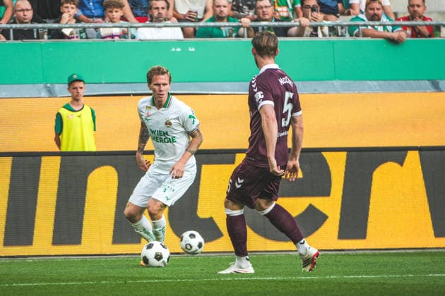 Soccer Austria UEFA Conference League 2026–2027 Playoffs, Second Leg, August 26, 2026 SK Rapid Vienna (Austria) vs. Heart of Midlothian FC (Hearts) (Scotland) Weststadion, Vienna, Austria Tonni Adamsen SK Rapid Vienna with Jamie McCart Heart of Midlothian FC Copyright: xLukasxBierederx