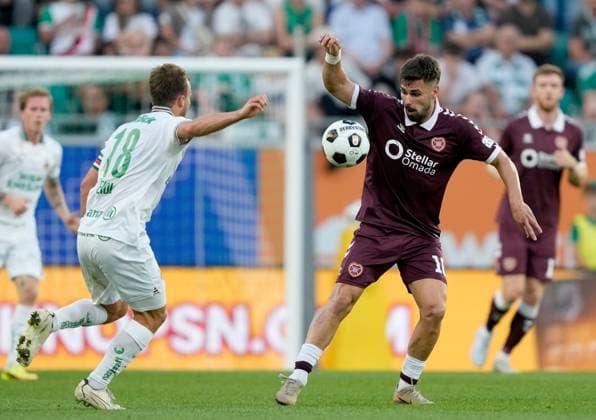 Claudio Braga of Heart of Midlothian in action against Tobias Gulliksen of SK Rapid during a UEFA Conference League Play-Off Second Leg match between SK Rapid and Hearts at Weststadion on August 26, 2026 in Vienna, Austria. Rapid Vienna v Heart of Midlothian, UEFA Conference League, Play-Off Round, Second Leg, Football, Allianz Stadion, Vienna, Austria - 26 Aug 2026Vienna Allianz Stadion Austria  Copyright: xChristianxHofer Shutterstockx 17115048bg